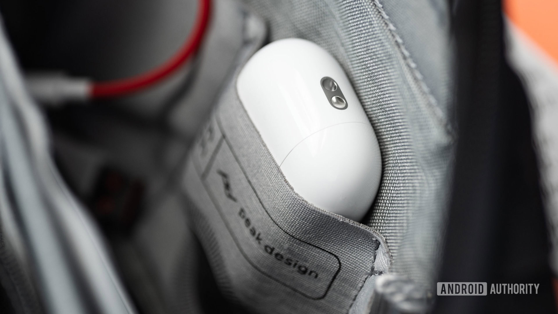Apple AirPods Pro 2nd generation true wireless earbuds case lanyard loop Apple AirPods Pro (2nd generation) charging case lanyard loop while the case rests in a tech pouch.