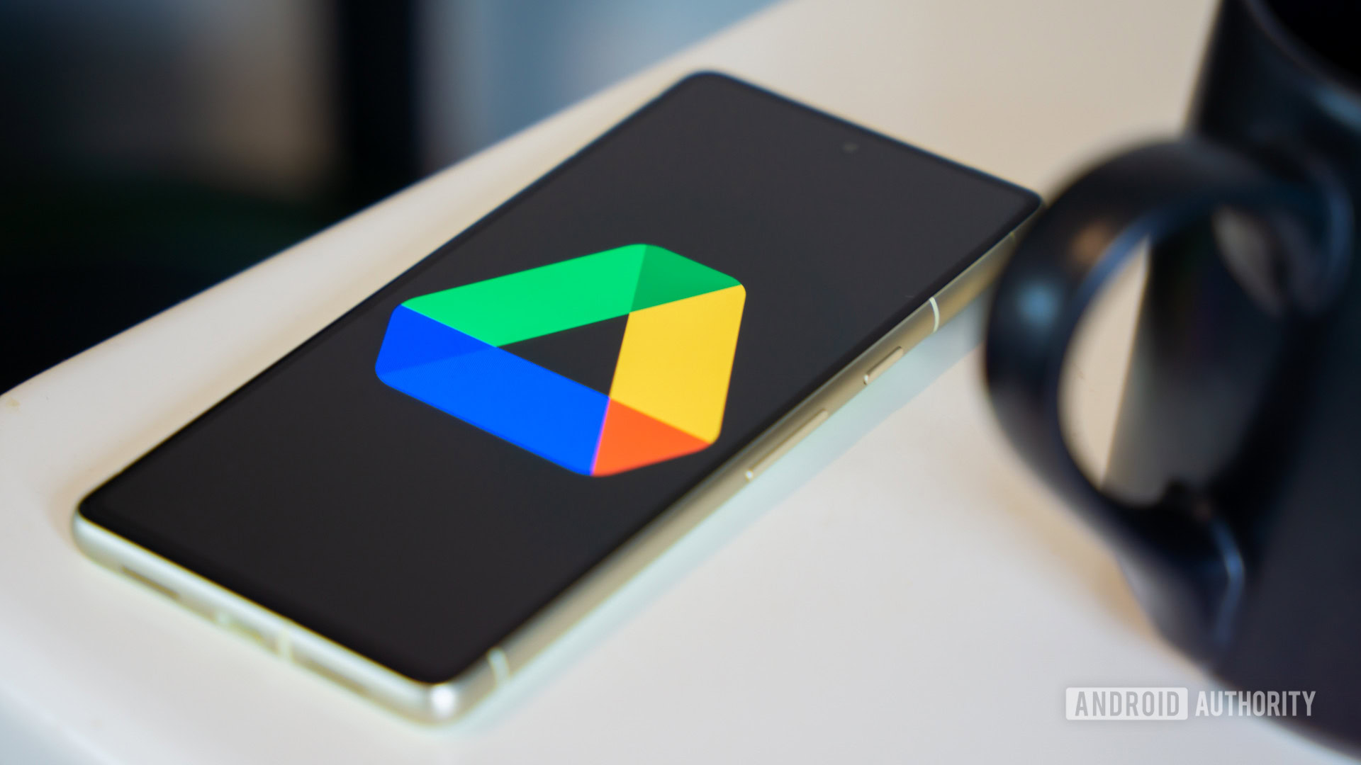 Google Drive logo on smartphone laying on desk Stock photo 1 Google Drive logo on smartphone laying on desk Stock photo 1