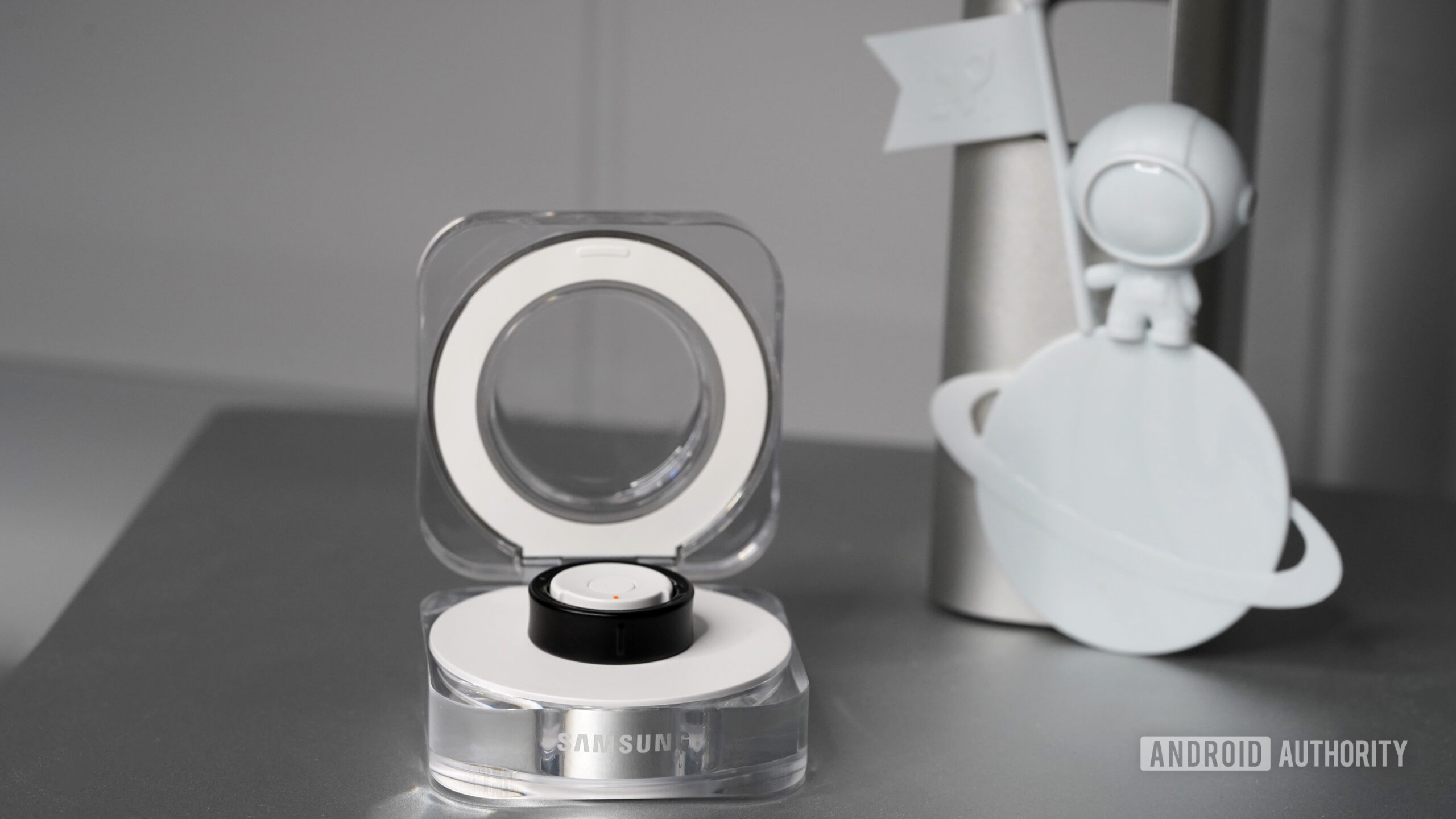 Samsung Galaxy Ring Charging Case Open A Samsung Galaxy Ring rests in its open clamshell charging case.