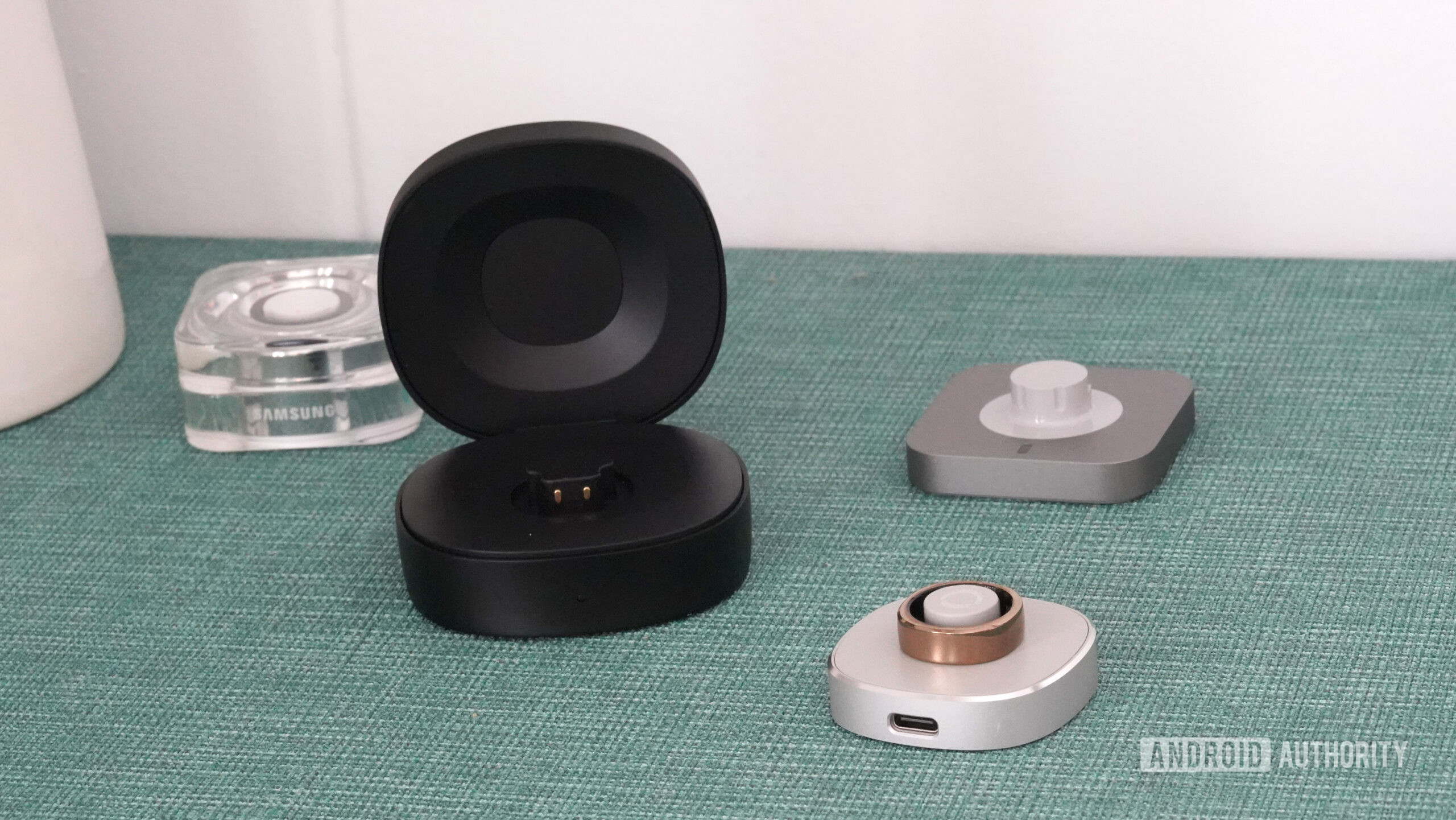 Smart Ring Chargers A variety of smart ring chargers highlight the difference between puck-style and clam-style chargers.